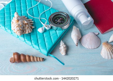 Accessories For A Bright Summer Sunny Holiday In The Resort. Items For Travel To The Sea Laid Out On A Wooden Table. Top View