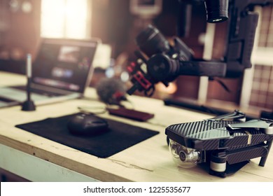 Accessories included for youtuber or vlogger create content video. Camera setting on Gimbal stabilizer drone and laptop. - Powered by Shutterstock