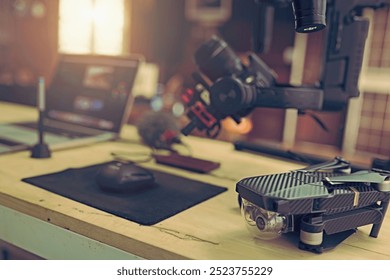 Accessories included for youtuber or vlogger create content video. Camera setting on Gimbal stabilizer drone and laptop. - Powered by Shutterstock