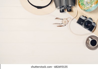 Accessories for travel top view on white wooden background with copy space. Adventure and wanderlust concept image with travel accessories. Preparing for an exotic trip, journey and sightseeing. - Powered by Shutterstock