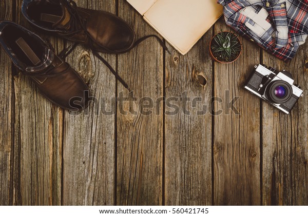 Accessories for\
travel top view on wooden background with copy space. Adventure and\
wanderlust concept image with travel accessories. Preparing for an\
exotic trip, journey and\
sightseeing.
