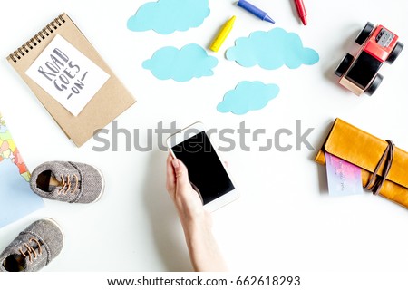 accessories for treveling with children and mobile phone on white background top view mock-up