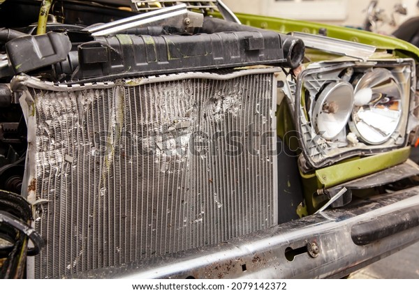 Accident, Car crash collision. Closeup shot of a\
crashed oldtimer cars front with Vehicle Radiator. Broken old car,\
detailed close-up