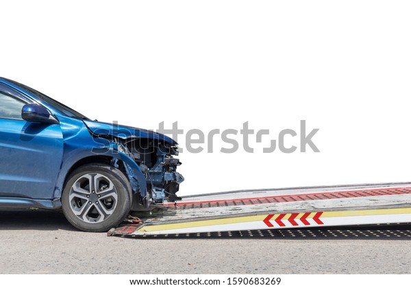 accident Car Slide on  truck for\
move. Blue car have damage by accident on road take with slide\
truck move . Isolate on white background save with clipping\
path.