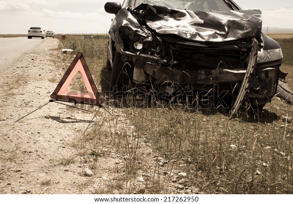 accident car and
warning triangle beside
road