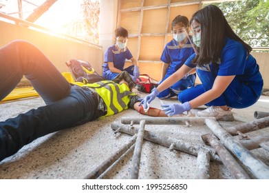 Accident At Construction Site. Physical Injury At Work Of Construction Worker. First Aid Help Construction Worker Who Has An Accident At A Construction Site. Accident In Constructions Work.