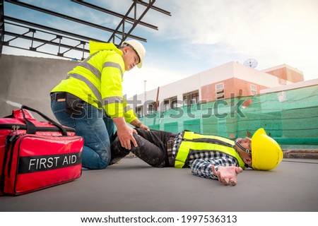 Accident at construction site. Physical injury at work of construction worker. First Aid Help a construction worker who accident at construction site. First Aid Help, accident at work.