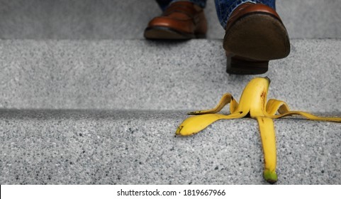 Accident in Daily Life Concept. Man Stepping Down Stair on a Banana Peel. Insurance or Business Metaphor