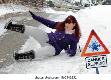 Accident Danger In Winter. Danger Slipping. A Woman Has Slipped And Has Fallen Down