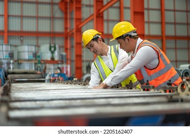 Accident in factory, male engineer feeling pain his arm got stuck in machine while working in production line factory.Safety man support helping and first aid him. - Shutterstock ID 2205162407