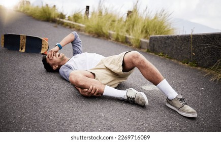 Accident, fall and knee injury with a skater man on the ground, lying down in pain after falling down. Sports, training and anatomy with a young male suffering a skateboard emergency outdoor - Powered by Shutterstock