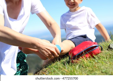 An Accident On A Mountain Trail. The Child Twisted His Ankle During A Mountain Tour. Wound Broken Leg.