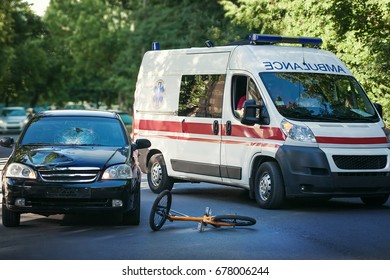 Accident On The Road. The Car Hit A Bicyclist. The Ambulance Takes The Victim