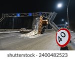 An accident on the road, a large truck caught a metal support with its body and reared up on two rear wheels