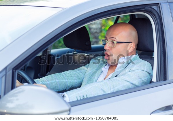 Accident. Scared funny looking\
young man driver in the car. Human emotion face expression. Side\
window view of inexperienced anxious motorist he is about to hit\
the car