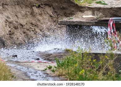 Accident Sewerage System. Water Supply Failure. Breakthrough Of The Water Supply System. A Fountain Of Water Flows Out Of The Sewer Under High Pressure. Wet Soil. Kyiv. Ukraine.