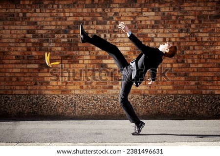 Accident, slip and banana peel with a business man in the city, falling by mistake on a street. Walking, step and unlucky with a young professional employee in an urban town for his commute to work