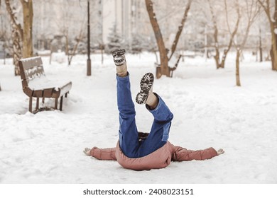 Accident in Winter. Falling Girl Child is Lying Upside down on Snow Slippery Road. Children Insurance. - Powered by Shutterstock