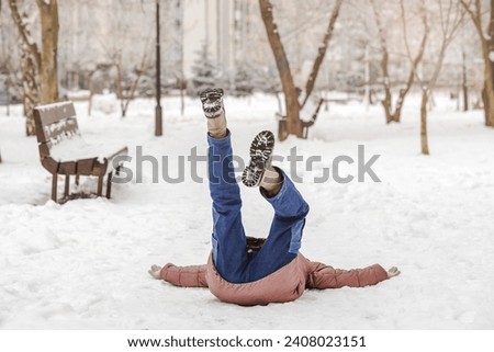 Accident in Winter. Falling Girl Child is Lying Upside down on Snow Slippery Road. Children Insurance.