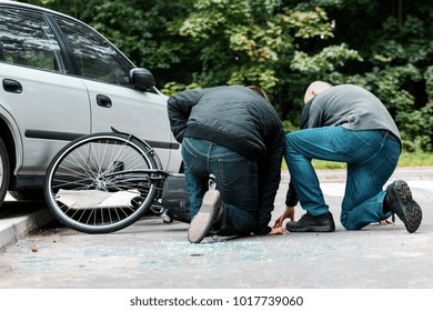 Accident Witness Helping An Injured Cyclist Hit By A Car