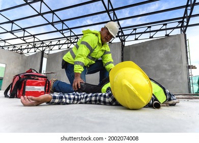 Accident at work of construction worker at site. Builder accident falls scaffolding on floor, First aid team rushed in to take care prepare helps employee accident. Safety in work concept.