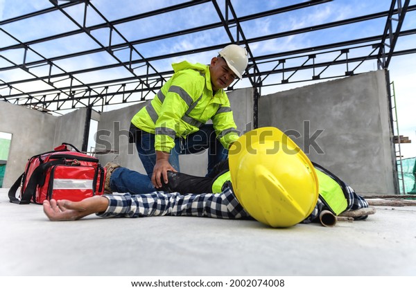 Accident
at work of construction worker at site. Builder accident falls
scaffolding on floor, First aid team rushed in to take care prepare
helps employee accident. Safety in work
concept.
