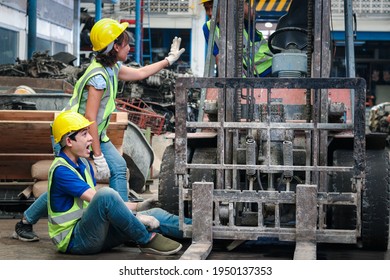 Accident At Workplace, Industrial Engineer Worker Wearing Helmet Hit By Forklift Car At Manufacturing Plant Factory Construction Site Building, Man Leg Stuck In Forklift, Colleague Try To Help Him