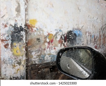 Accidental Art. Random Colours On A Wall Look Artistic Through A Rain Kissed Car Glass.