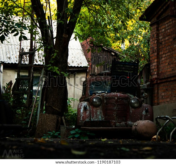Accidentally found an\
abandoned car old dirty yard trees nature green village old retro\
car vintage\
closeup