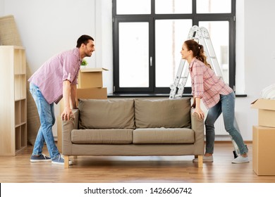 Accommodation, Repair And Real Estate Concept - Happy Couple Moving Sofa At New Home