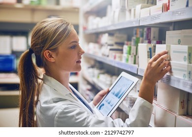 According To This Online Tool, This Medication Will Work Best. Shot Of A Pharmacist Using Her Digital Tablet While Working In A Isle.