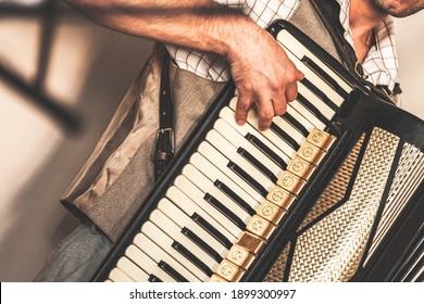 Accordionist plays accordion. Close-up photo with soft selective focus