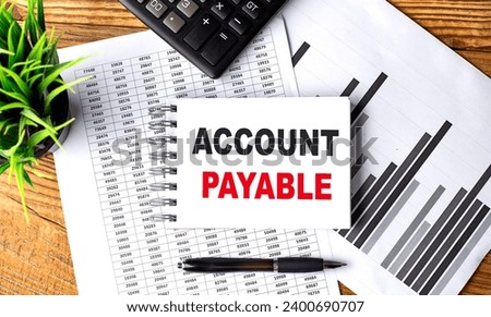 ACCOUNT PAYABLE text on notebook with chart and calculator