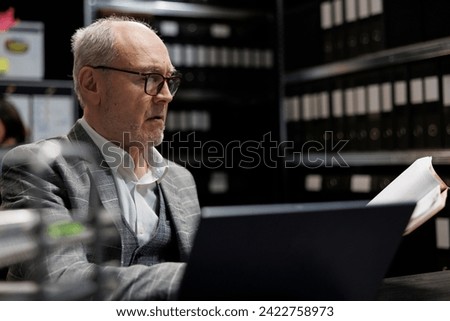 Accountancy businessman checking bookkeeping analytical data paperwork. Administration employee in business company file cabinet repository filled with flowcharts and folders