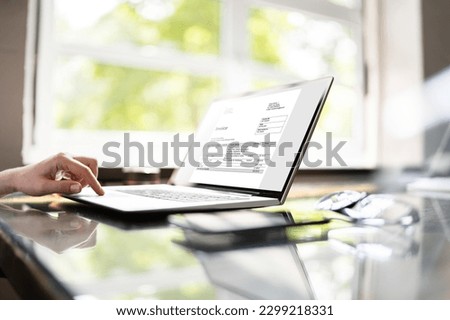 Accountant Calculating Electronic Invoice Or E Bill At Desk