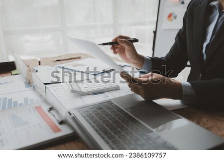 Accountant calculating numbers on calculator, Auditor is working on accounting in the office, Businessman calculating the financial liquidity of the company, accounting idea.