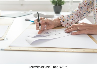 Accountant Or Financial Adviser Checking And Comparing Receipts While Making A Final Report, Working At Her Desk With Calculator Alongside.
