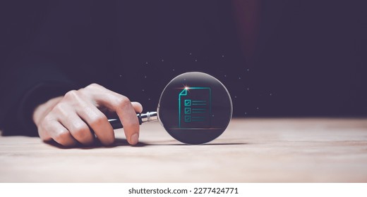 accountant holding a magnifying glass ,Show document audit concept quality assessment with a checklist business document evaluation process ,process of reviewing plans and evaluating their correctness - Shutterstock ID 2277424771