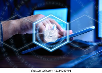 Accountant man using tablet computer and digital lock icon hologram with circle binary numders and world map. Cyber security and digital protection concept.