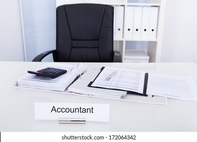 Accountant Name Plate On Desk With Empty Chair