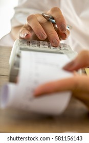 Accountant Using Adding Machine To Do The Expenses Balance, Low Angle View.