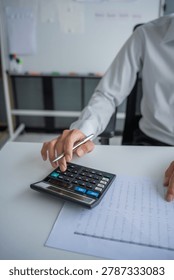 Accountant using calculator calculate document.