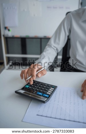 Accountant using calculator calculate document.