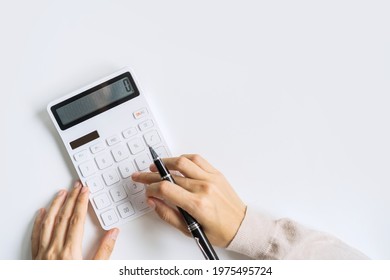 Accountant using calculator on desk office on white background with copy space, Top view - Shutterstock ID 1975495724