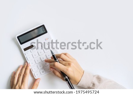 Accountant using calculator on desk office on white background with copy space, Top view