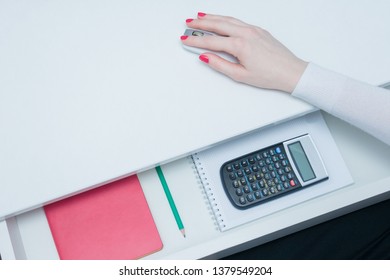 Accountant using a computer mouse, white desk, open shelf, calculator and stationery, female hand, close up, top view, background, copy space, advertising