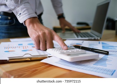 Accountant verify the business and saving money stacking gold coins with calculator. Accountancy Concept. - Shutterstock ID 735972115