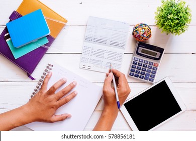 Accountant Verify The Saving Account Book And Statement Of Financial Statements / Bookkeeping / Accountancy Concept.