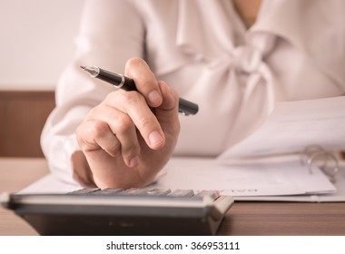 Accountant Women Or Auditor Using Calculator For Check The Numbers On The Balance Sheet. Concept Of Accounting, Bookkeeping,internal Audit.