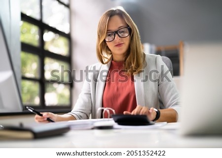 Accountant Women At Desk Using Calculator For Accounting